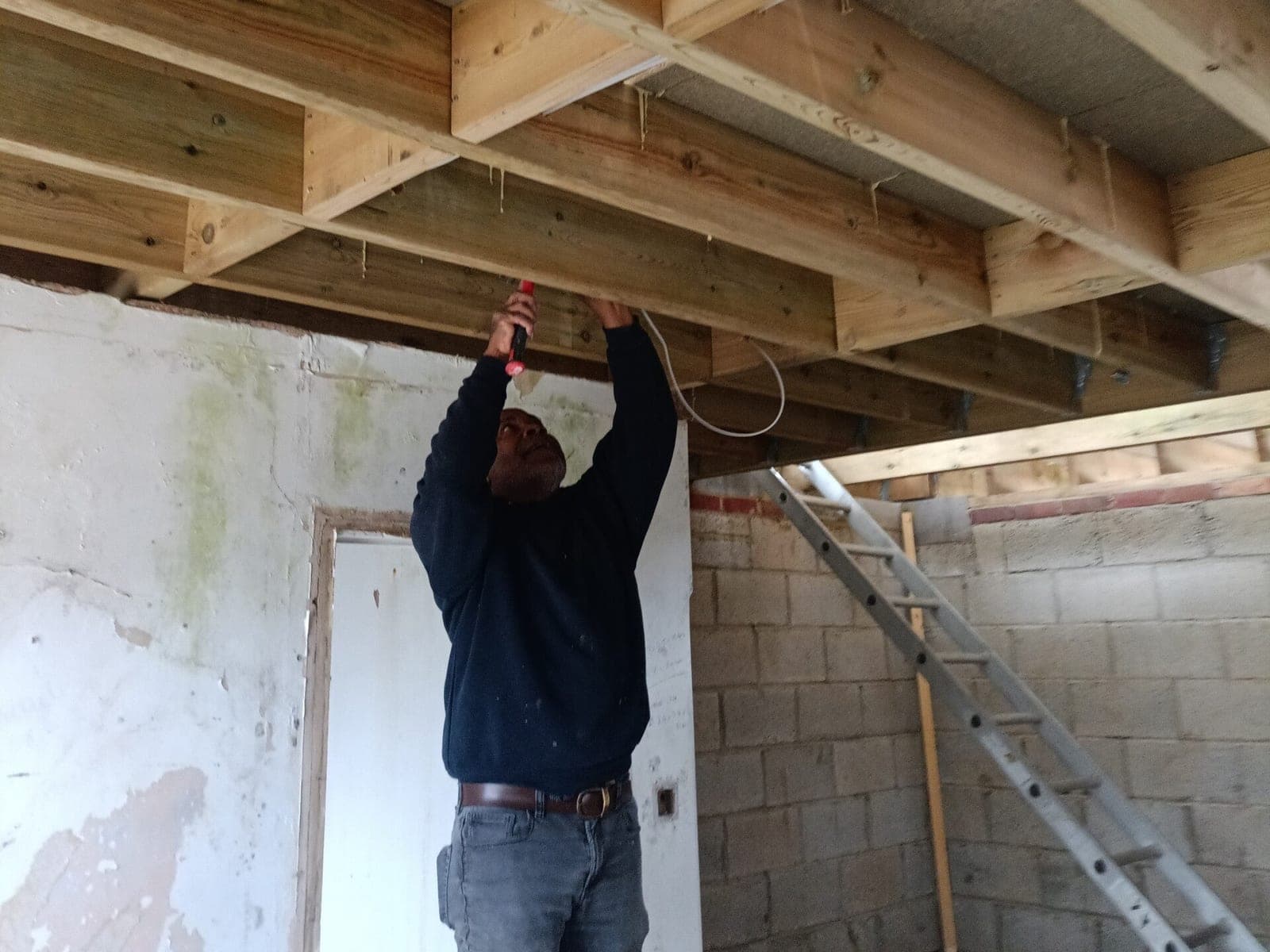 New cables being run through the ceiling joists of a building project in the Whitstable area